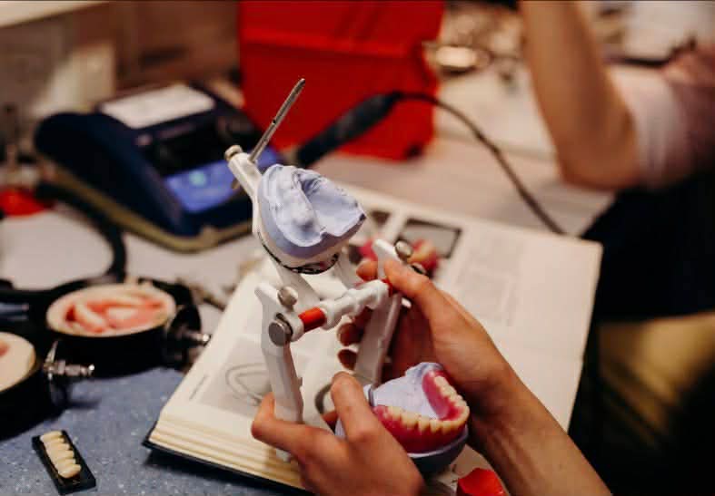 Crafting a custom denture on the articulator at Apple Smile